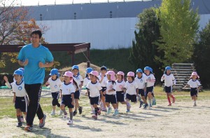 毛利康人園長と園庭を走る園児