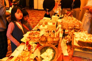 たくさんある菓子の中からどれにしようか選ぶ子供たち