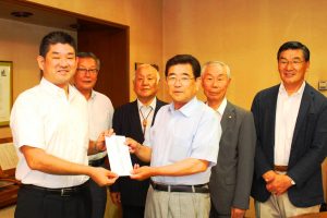 仲川げん市長(左)に義援金を手渡した奈良市自治連合会の梅林聰介会長(右から3人目)ら