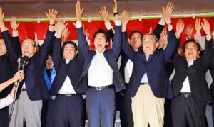 初当選を決め、支持者と万歳する佐藤啓氏（中央）