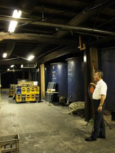 瓶詰めした酒を貯蔵する酒蔵は夏でもひんやりとして心地良い。酒の仕込みなどに使う大きな桶なども見学できる