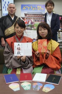 「みつきうまし祭り」に合わせ作られた朱印帳などを手にする関係者