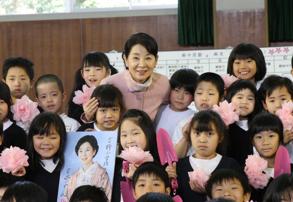 児童と笑顔で写真を撮る女優の吉永小百合さん